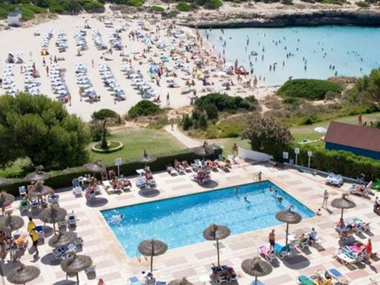 The swimming pool and beach at Hotel Cala n Bosch on Menorca